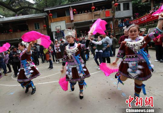 广西苗寨芦笙踩堂引游客围观