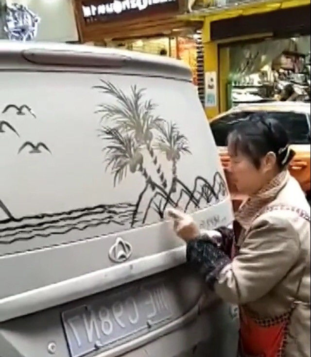 小伙看到大妈在自己车上乱画,准备上前理论,结果却是佩服不已